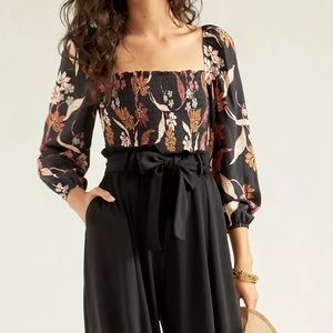 ANTHROPOLOGIE DOLAN Collection Pilar Smocked Blouse Floral on black size Large.